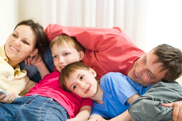 Family lying on the carpet — Stock Photo, Image