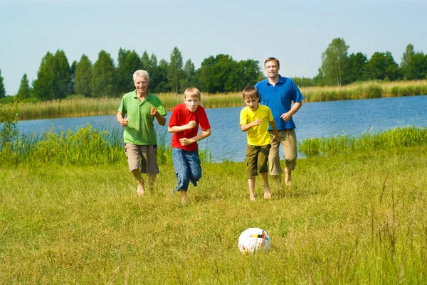 Happy family playing soccer — Stock Photo, Image