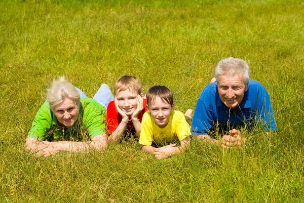 Elderly couple with their grandchildren — Stock Photo, Image
