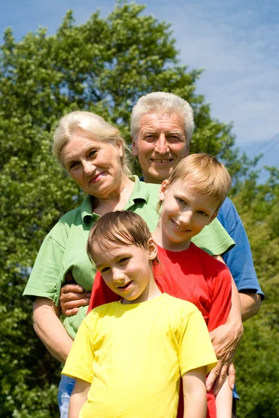 Couple with their grandchildren — Stock Photo, Image