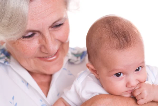 Elderly woman holding a newborn in her arms — Stock Photo, Image