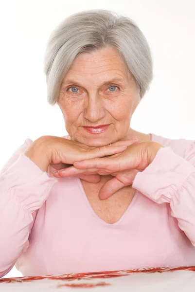Older woman on a white — Stock Photo, Image