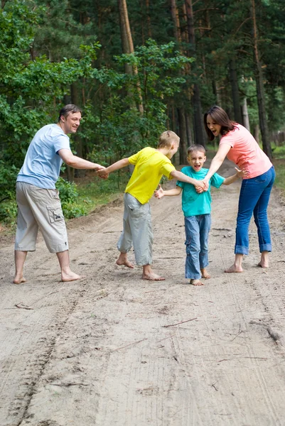 Família feliz andando na floresta — Fotografia de Stock