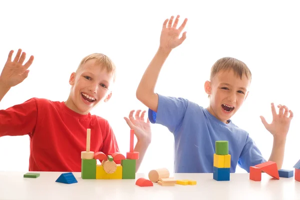 Two kids playin with brick-sat — Stockfoto