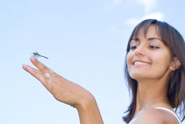 Smiling girl with a dragonfly — Stock Photo, Image