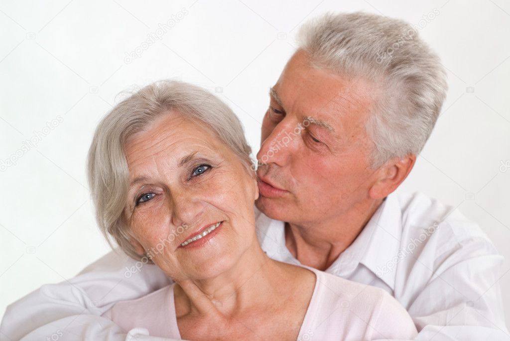 Elderly couple together on a white