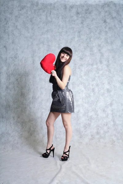 Gyönyörű fiatal nő gazdaság piros szív — Stock Fotó