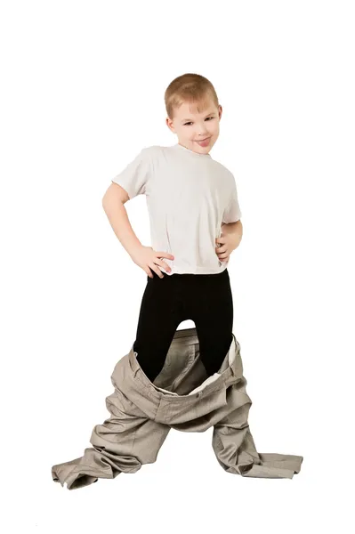 Мальчик в отцовских штанах — стоковое фото