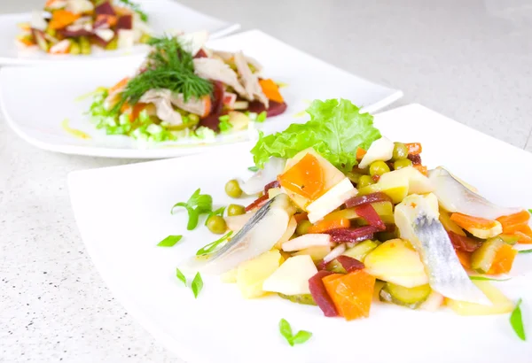 Salad of beetroot, carrot, potato, green leek and herring — Stock Photo, Image