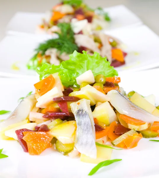 Salad of beetroot, carrot, potato, green leek and herring — Stock Photo, Image