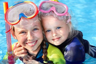 Children in swimming pool learning snorkeling. clipart