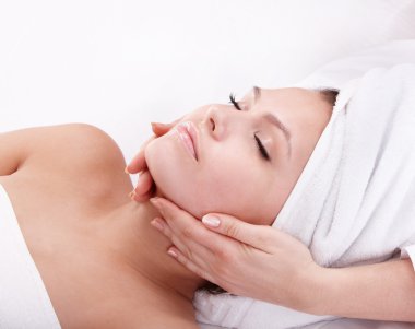 Young woman in spa. Facial massage. clipart