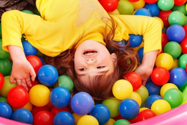 Happy child in group colourful ball. clipart