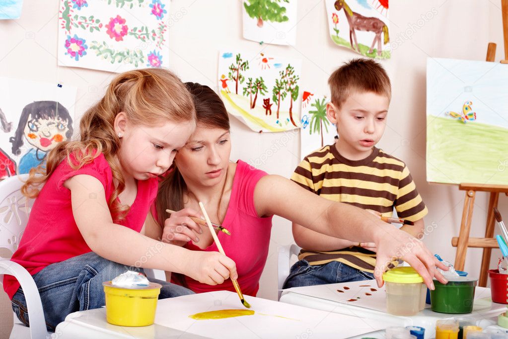 Children painting with teacher.