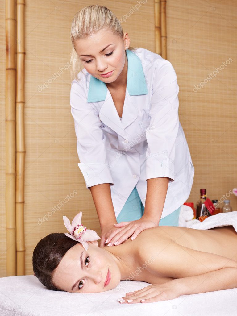 Young woman on massage table in beauty spa. Series.