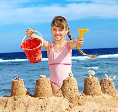 Child playing on beach. clipart