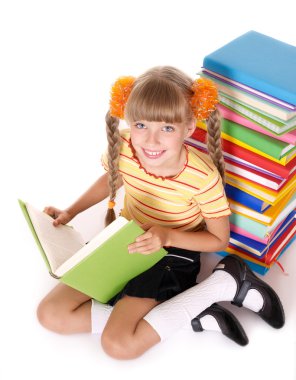 Schoolgirl reading pile of books.