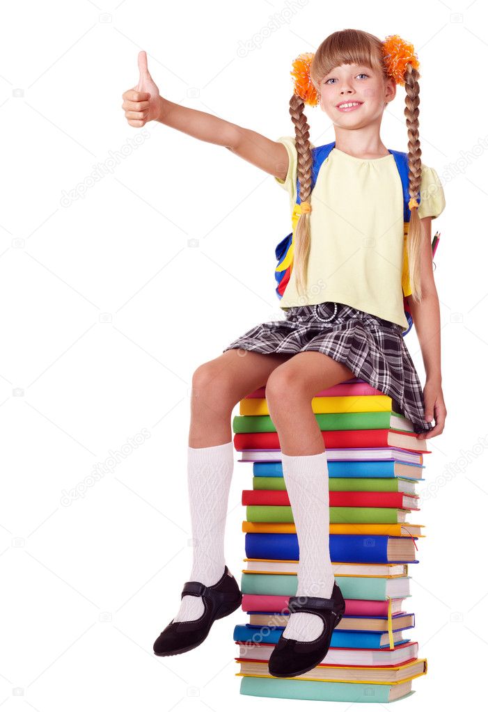 Girl sitting on pile of books showing thumb up.