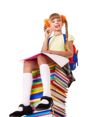 Schoolgirl sitting on pile of books.