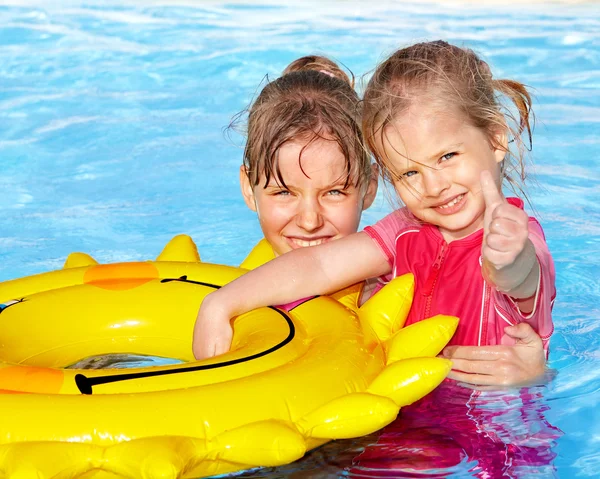 Children sitting on inflatable ring.. — Stock Photo, Image