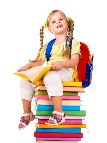 Dziecko siedzi na stos książek. — Zdjęcie stockowe