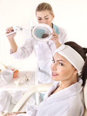 Woman on massage chair in beauty spa. clipart