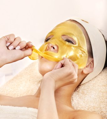 Girl with gold facial mask. clipart