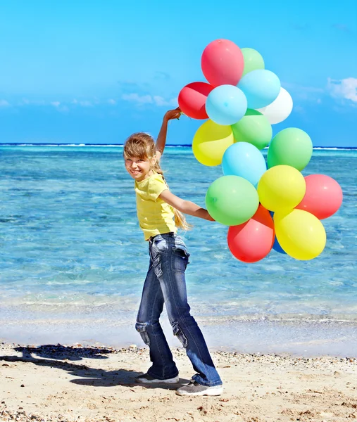 Bambino che gioca con i palloncini in spiaggia — Foto Stock