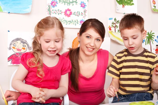 Children with teacher in play room. — Stock Photo, Image