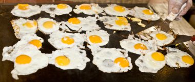 Fried egg in buffet restaurant. clipart