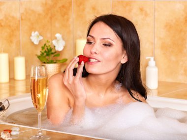 Woman relaxing in bath. clipart