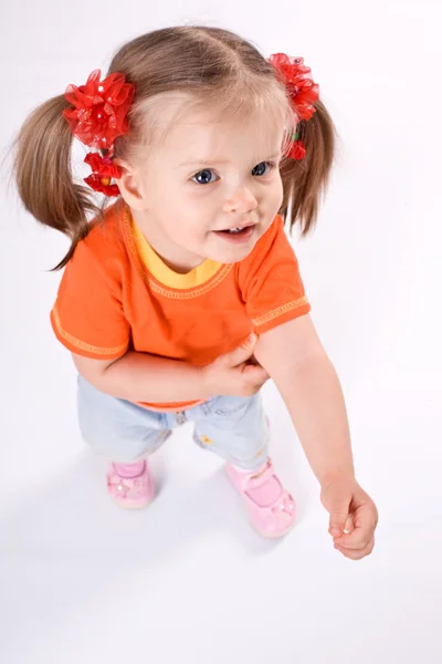 Barn flicka i orange t-shirt.white bakgrund. — Stockfoto