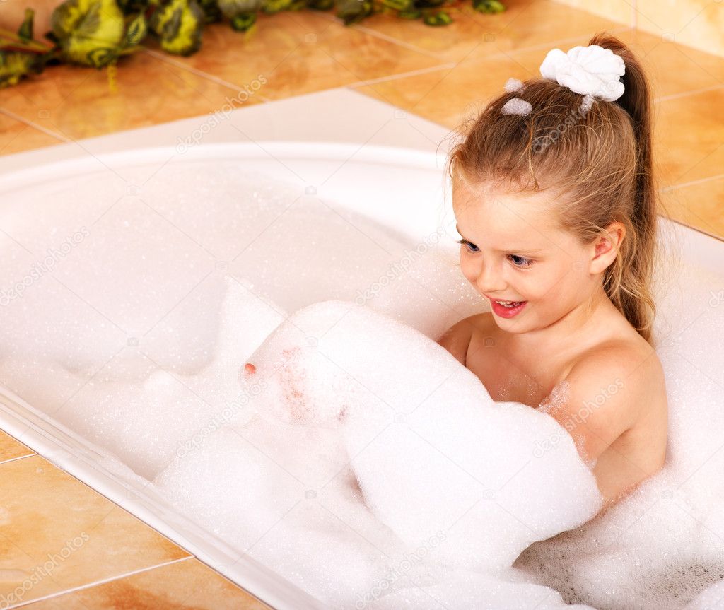 Kid washing in bath.