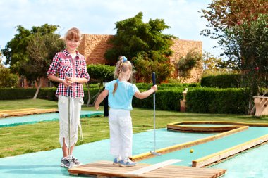 Little girl playing in park. clipart