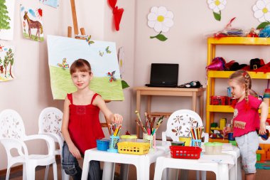 Group of children with colour pencil in play room. clipart