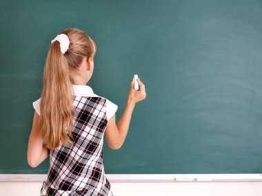 Schoolchild writing on blackboard. clipart