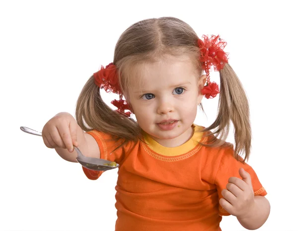 Dziewczynka w orange jeść gruszka. — Zdjęcie stockowe