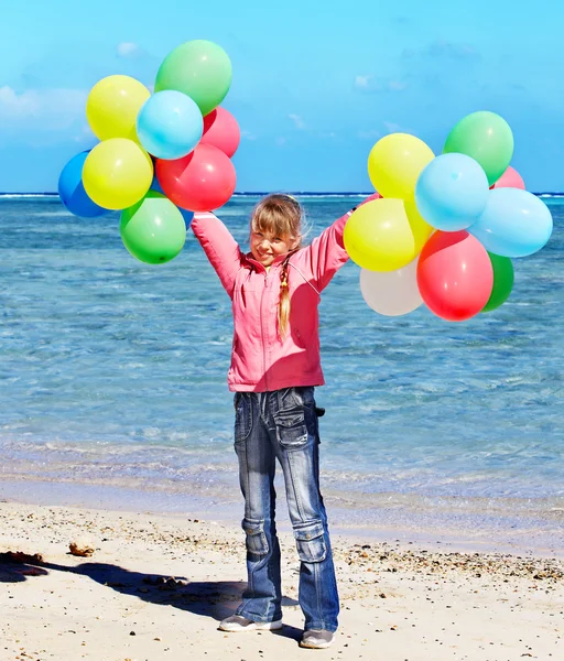 Niño jugando con globos en la playa — Foto de Stock