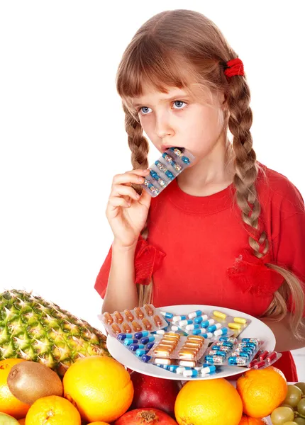 Child with fruit and vitamin pill. — Stock Photo, Image
