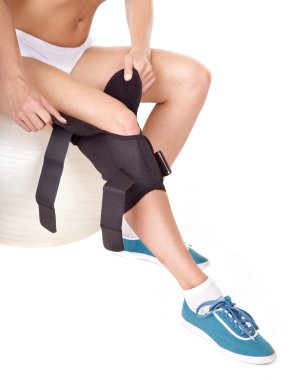 Woman with knee brace. clipart