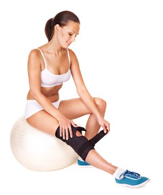 Woman with knee brace. clipart