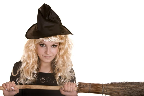 Halloween witch blond in black dress and hat on broom. — Stock Photo, Image