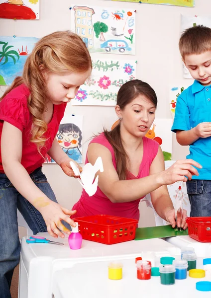 Child with teacher in play room. — Stock Photo, Image