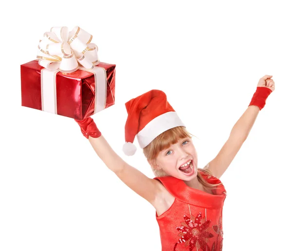 Child in santa hat holding red gift box. — Stock Photo, Image