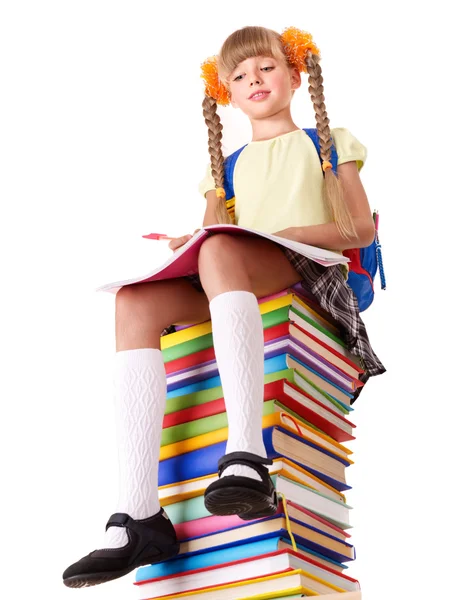 Colegiala sentada en un montón de libros . — Foto de Stock
