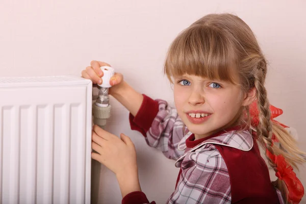 stock image Girl try open thermostat. Crisis.