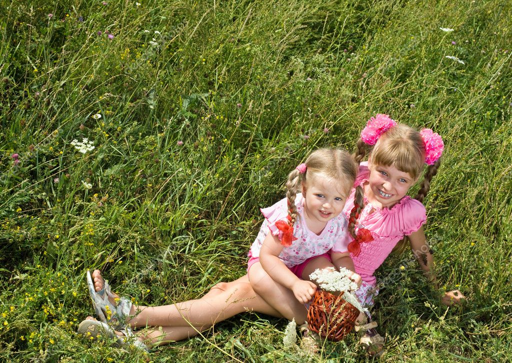 Little girls on green grass outdoor. — Stock Photo © poznyakov #6724054