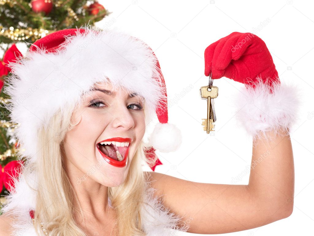Christmas girl in santa hat holding house keys.