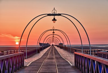 Sun setting on Southport pier clipart