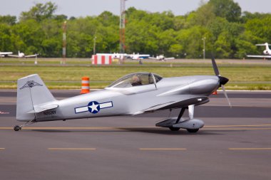 Small military plane on runway clipart